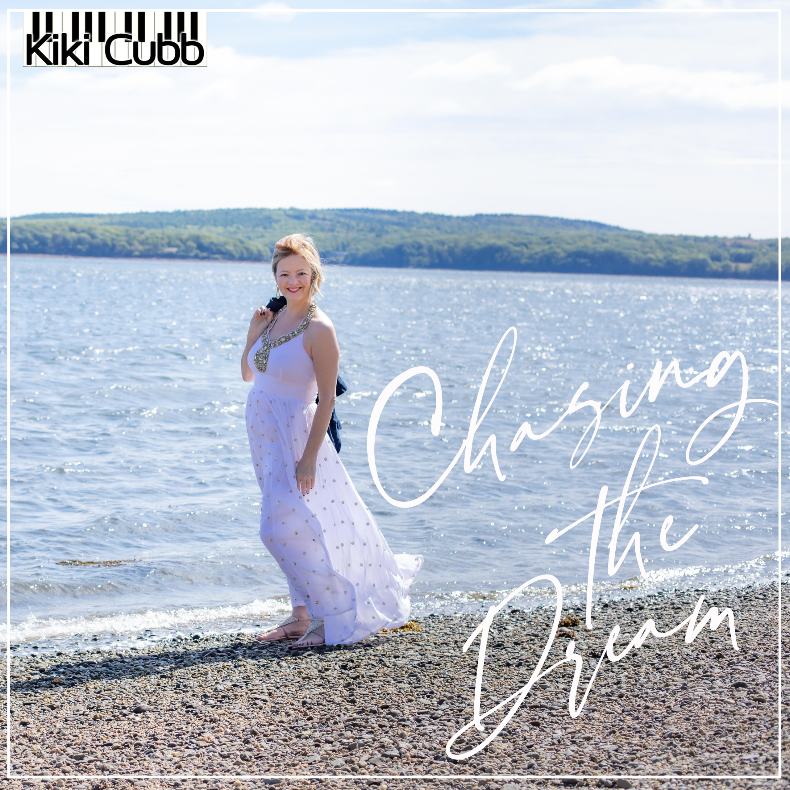 Kiki Cubb wearing a white dress walking along a rocky beach with the words "Chasing the Dream" and a logo that says "Kiki Cubb" with piano keys